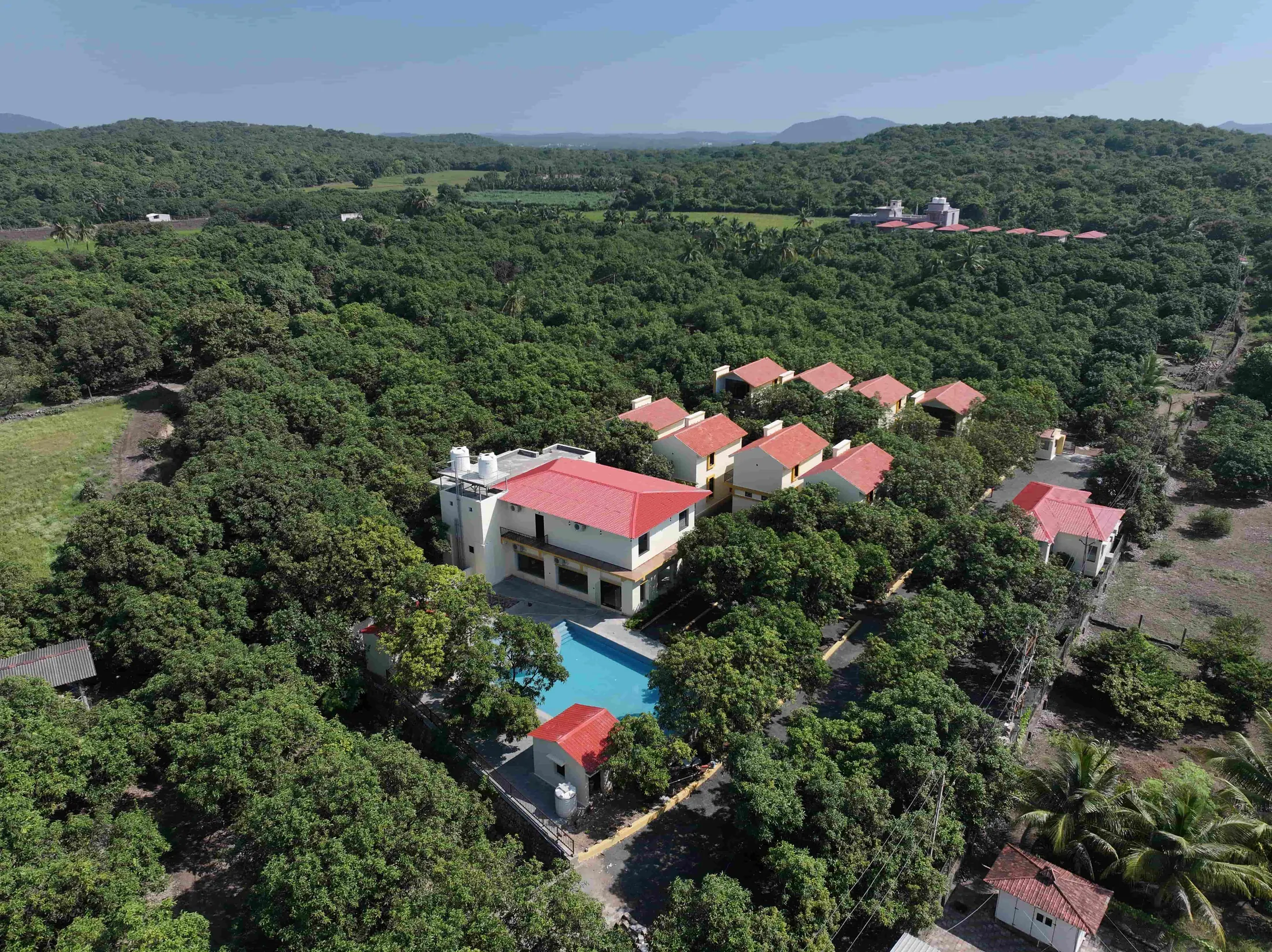 Aerial view of The Premier Girtara Resort surrounded by trees